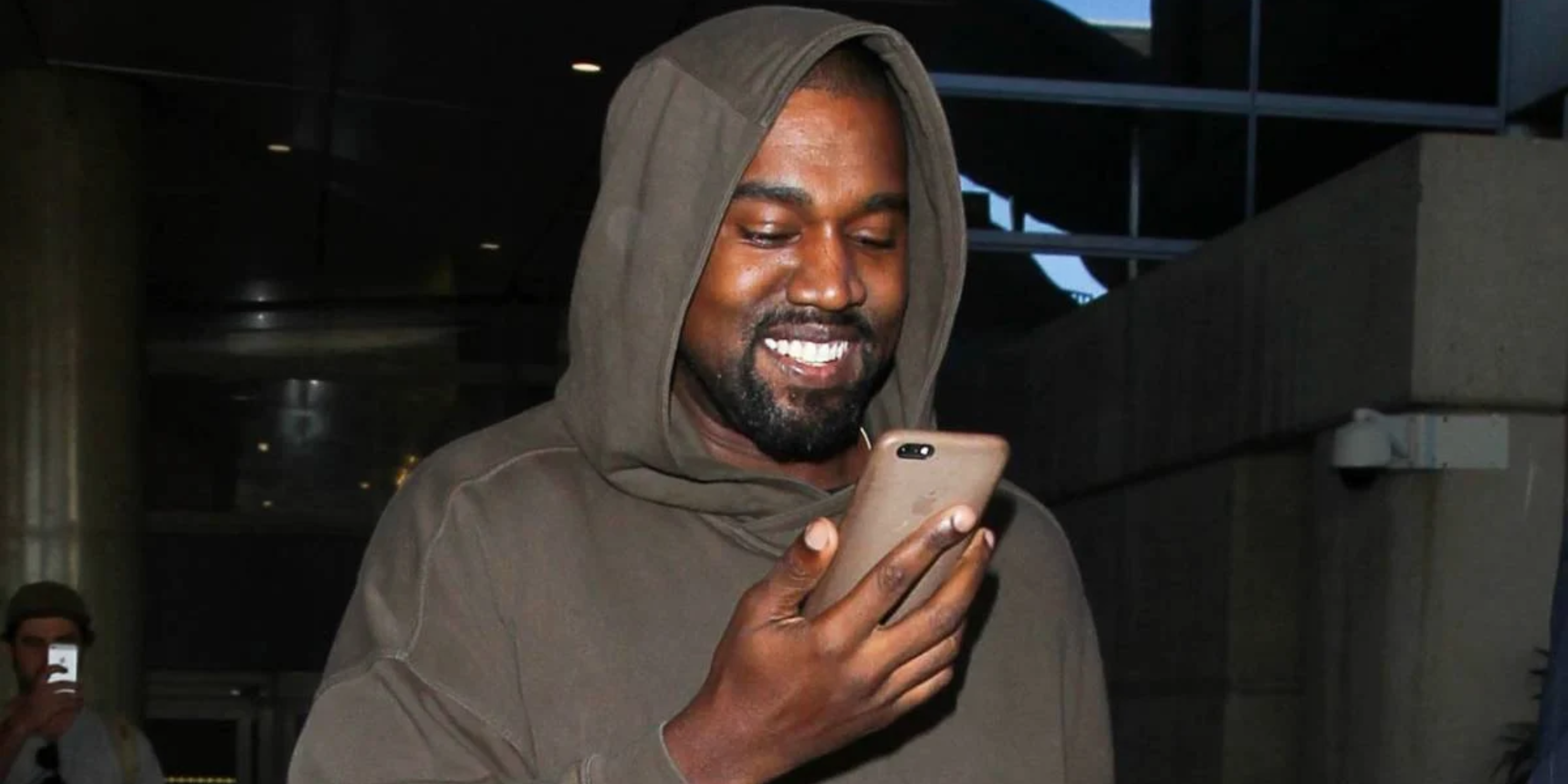 Kanye West looking down on his phone