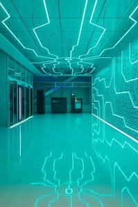 Liquid cooling system display at Global Switch data centre with modern circuit-inspired lighting.