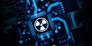 Microchip on a circuit board with a glowing nuclear hazard symbol.
