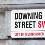 Downing Street street sign with digital code overlays, representing UK government and digital policy.