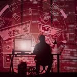 Silhouette of a technology professional working at a computer with red digital interface overlays, representing software development, cybersecurity, and digital technology.